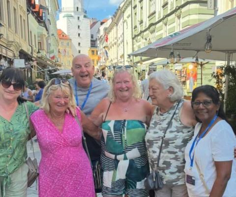 Group of people smiling on holiday on European street 
