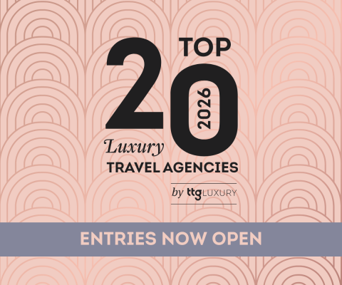 Promotional graphic with an Art Deco–style patterned background in soft pink tones. Large black text reads “Top 20 2026 Luxury Travel Agencies,” with smaller branding “by TG Luxury” beneath. A muted blue banner across the bottom says “Entries Now Open.”
