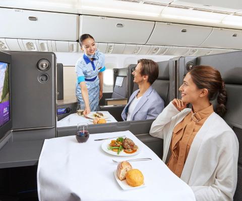 Cabin crew attending two passengers on an ANA flight