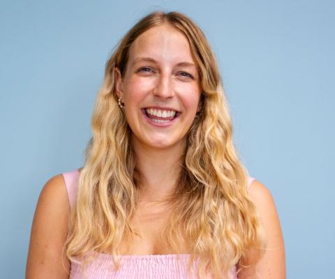 Young white woman with long wavy blonde hair smiling at camera 