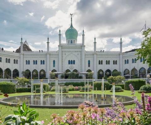 White palace-like hotel with green gardens 