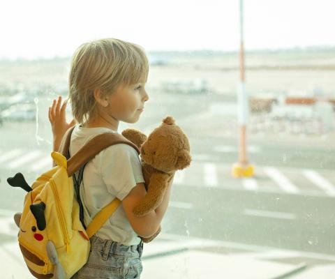 Child looking out of airport window