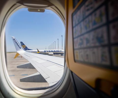 A Ryanair aircraft at the stand pictured through an aircraft window