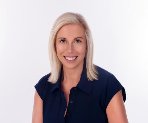 Headshot of woman with shoulder-length blonde hair smiling 