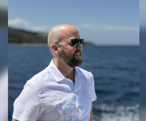 Man with sunglasses looking out to sea 