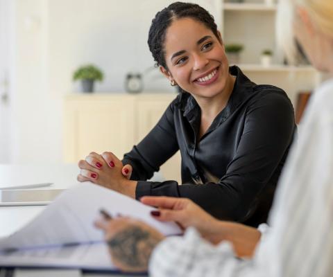 A job candidate pictured smiling with an HR manager