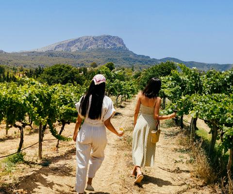 Two women walking through a vineyard in Mallorca