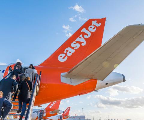 Passengers board an easyJet aircraft via the rear doors