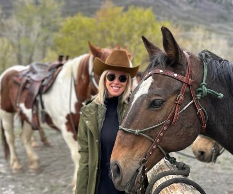 Blonde woman smiling with horse