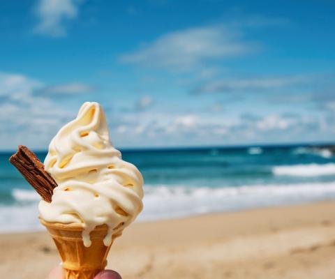 A person holding an ice cream on a UK beach