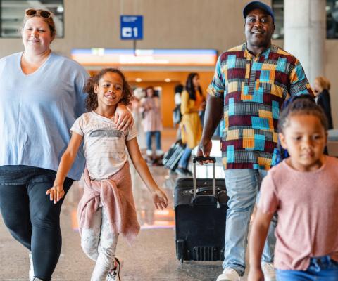 Family walking through airport 