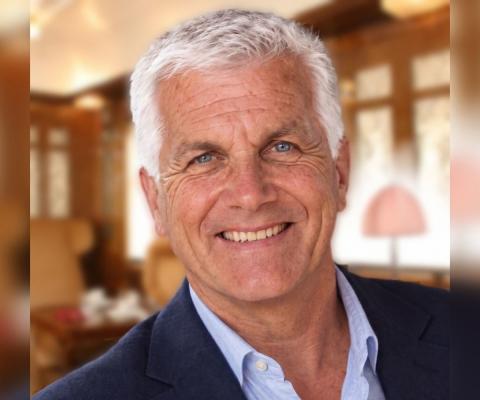 Professional photo of white man smiling with short white hair 