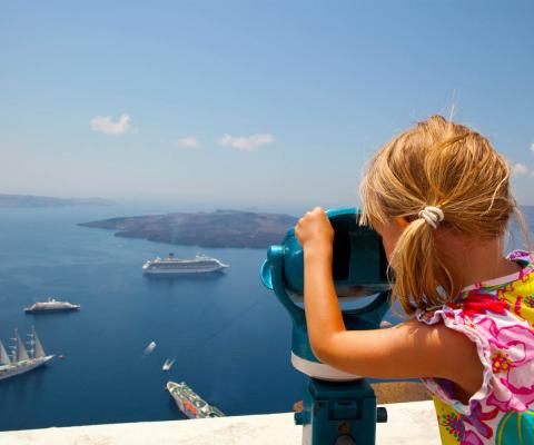 Girl looking at cruise ships (stock)