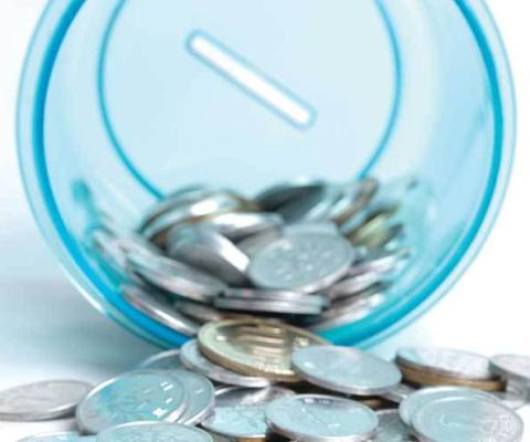 Money in a piggy bank cup