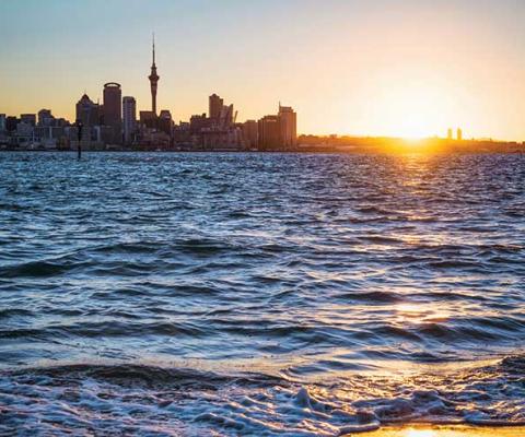 Auckland skyline sunset over sea