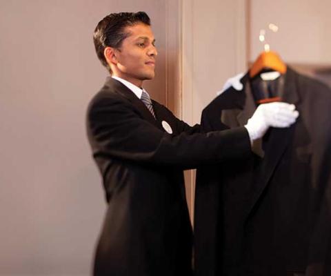 Butler combing a jacket