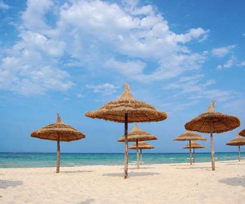 Parasols on the beach in Tunisia iStock-95341294