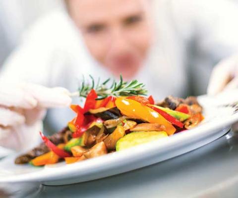 Chef applying finishing touches to dish iStock-495799458