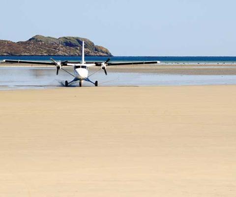 Light aircraft landing on beach iStock-174798675