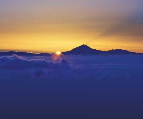 Sunset over mountain and cloud horizon