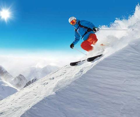 Downhill skier in the sun