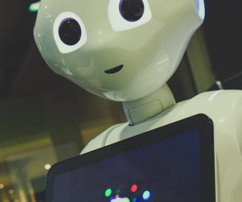 AI Robot holding tablet_Photo by Owen Beard on Unsplash.png