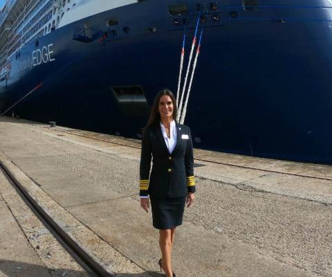 Captain Kate McCue beside Celebrity Edge