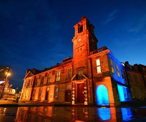 Several city landmarks have been lit up in blue and orange in tribute to John Hays