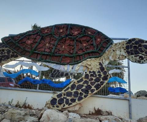 Made entirely from plastic waste, the turtle artwork, named "Calypso", is in a "prominent" position at Ayia Triada beach to raise awareness of the issue of plastic pollution