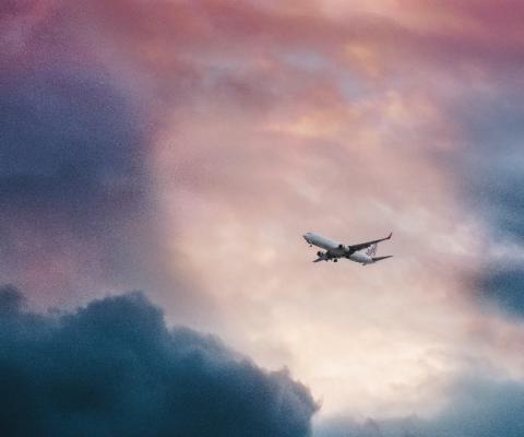 A plane emerges from stormy skies (Credit: Leio Mclaren/Unsplash)