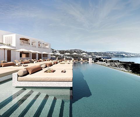 Guests can relax at the pool, looking out across the Aegean Sea