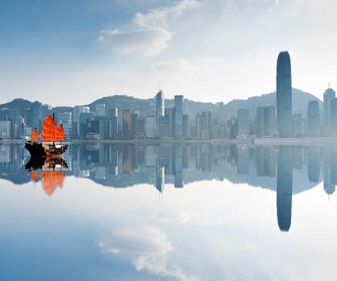 Hong Kong skyline and junk boat iStock