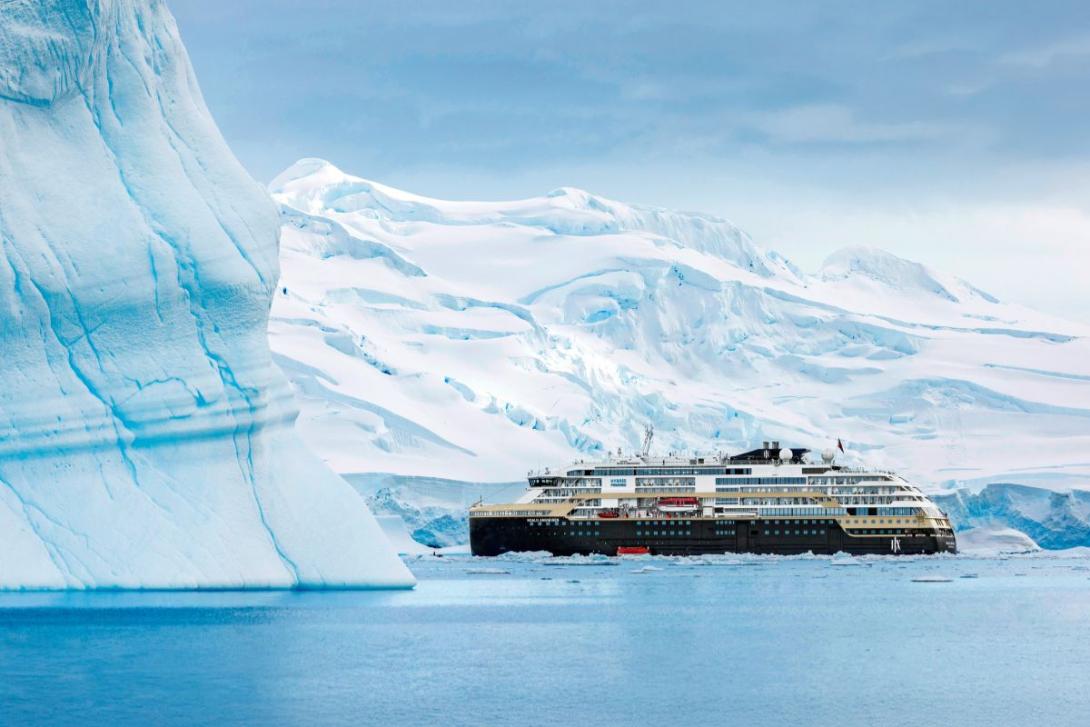 HX Expedition ship among large ice-covered landscape