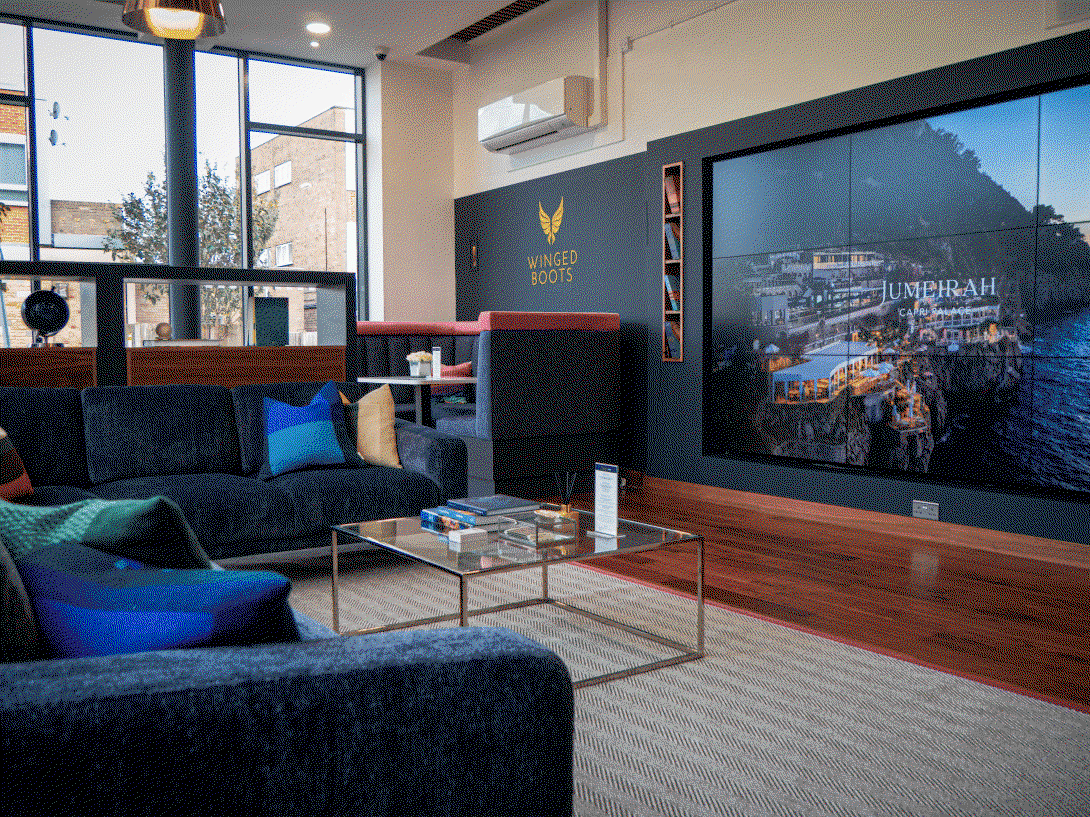 Winged Boots store in Shenfield Travel lounge for clients with large TV screen