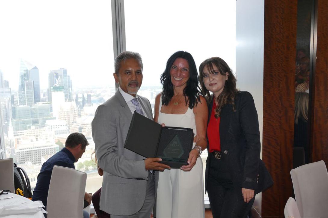 Smiling woman holding award