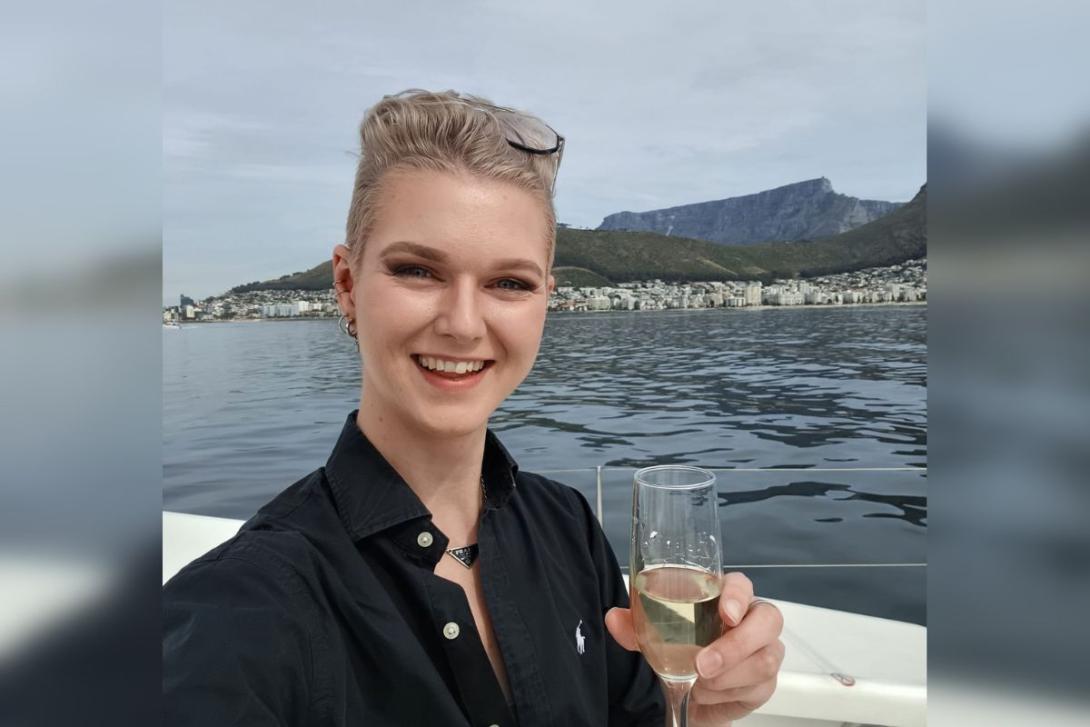 Woman with short blonde hair smiling with champagne glass