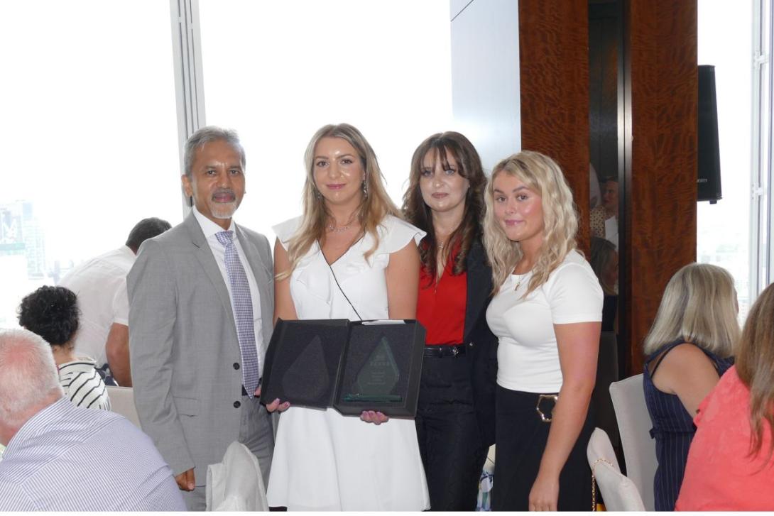 Group of travel agents holding awards