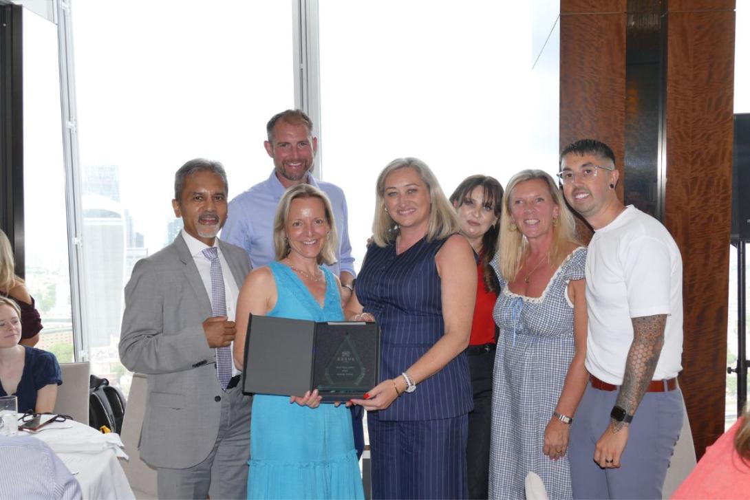 Group of people holding awards