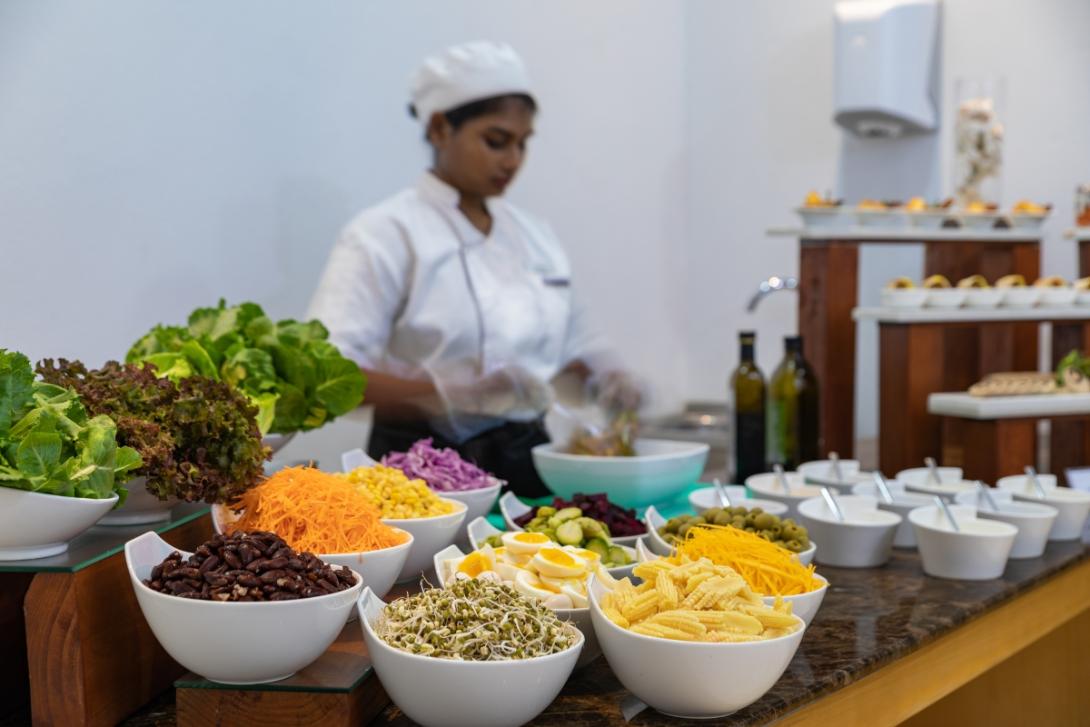 Female chef serving salad buffet