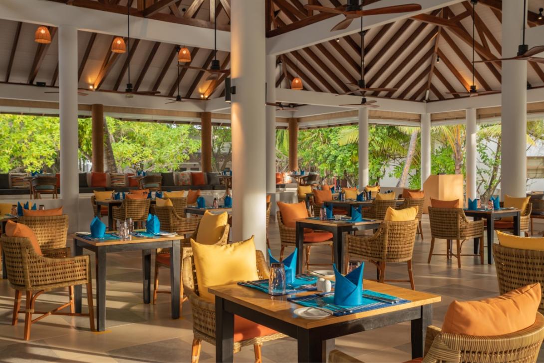 Restaurant with colourful seating and wood beamed ceilings in the Maldives