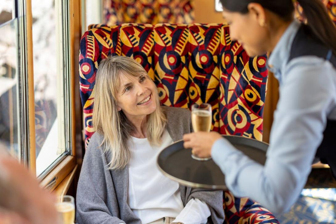 Rhätische Bahn Woman being served a drink on a train