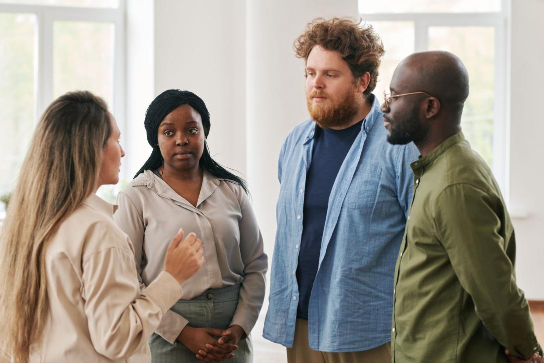 Group of young interracial people standing and talking