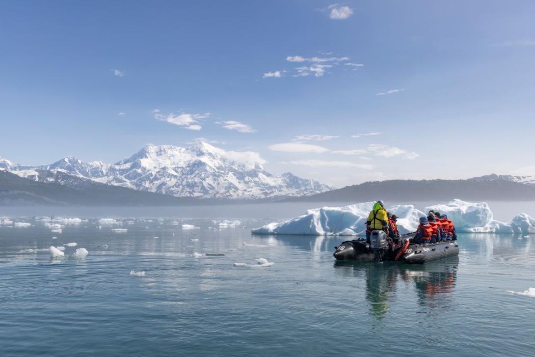 HX Expeditions / Ted Gatlin People on small inflatable boat floating around Alaska's icefjords