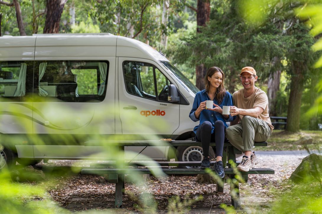 A couple sat outside a motorhome