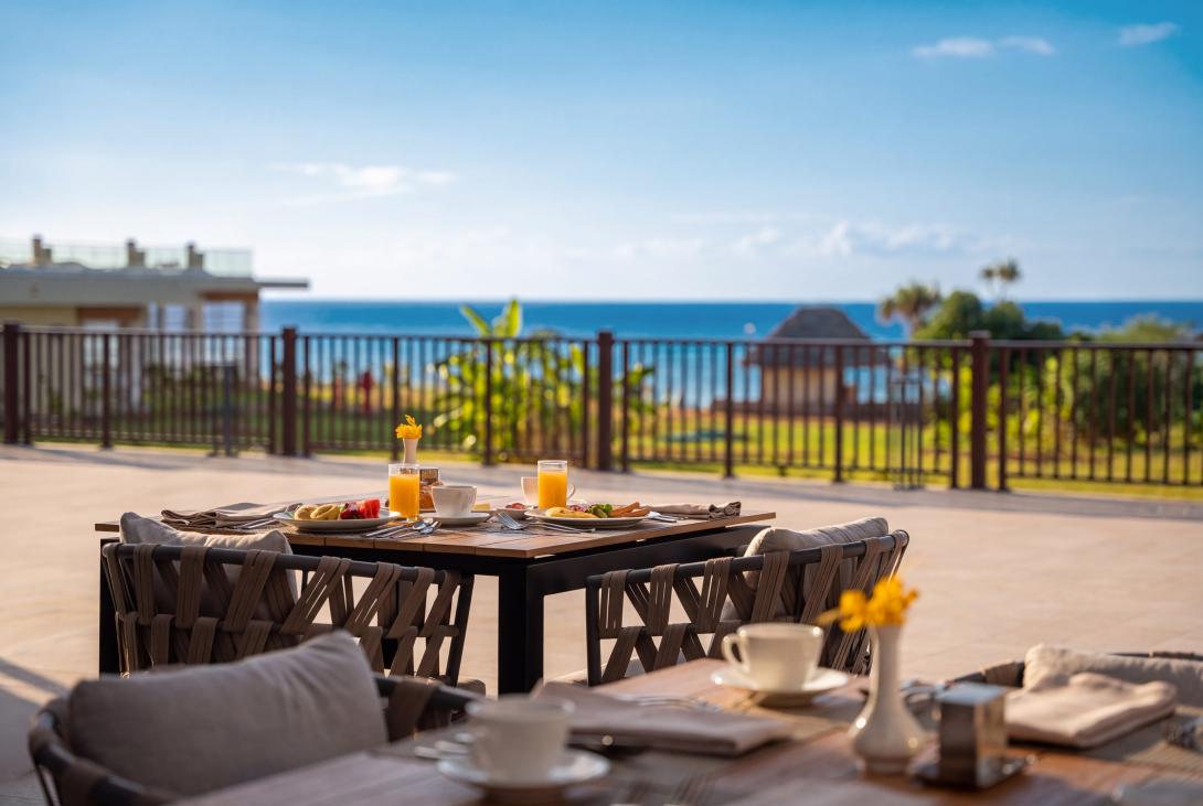 Iberostar Hotel Group Table set up with food and a view of the ocean behind