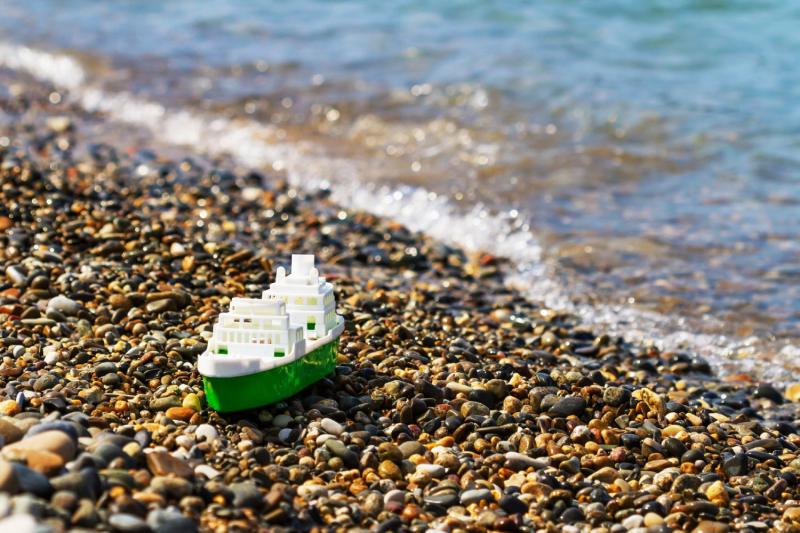 A small plastic ship on the shore