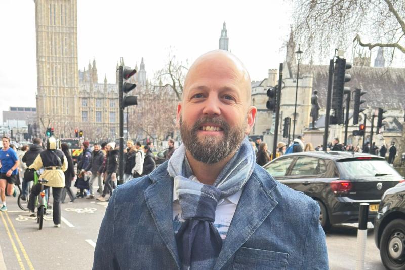Man smiling in front of Big Ben 