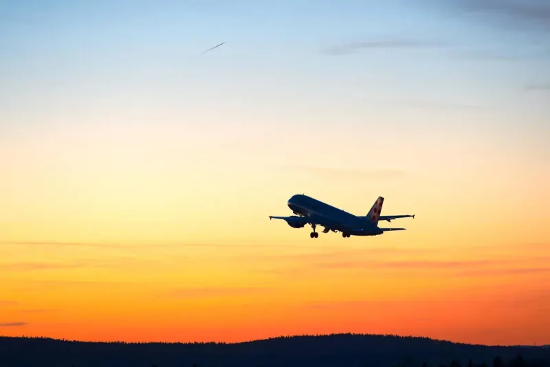 An aircraft taking off at dusk