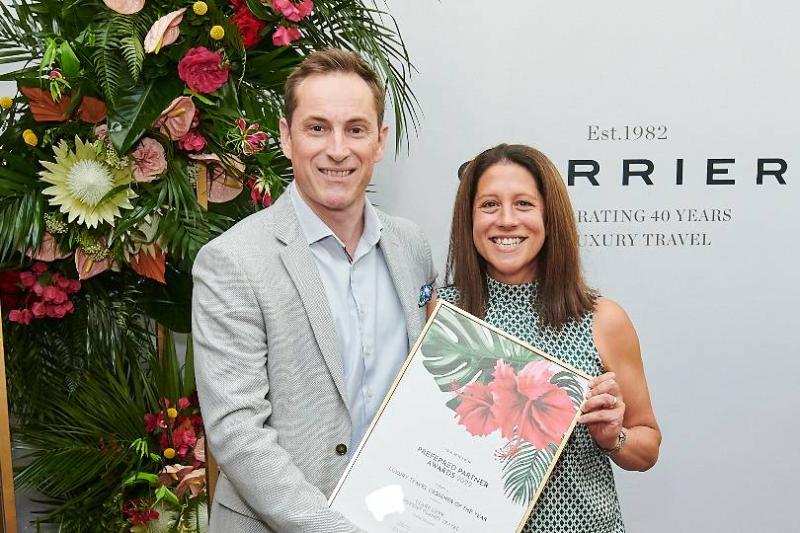 Clare Levy from Different Planet Travel receives her Luxury Travel Designer of the Year UK award from Carrier's Rick Milne