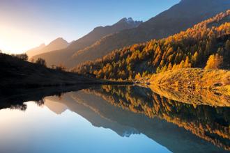 Autumn view of lake with trees lining hillside